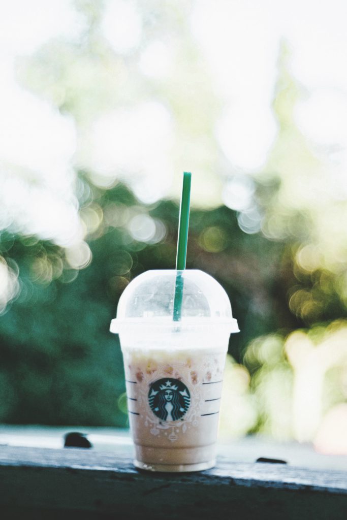 Starbucks smoothie on a grey bench