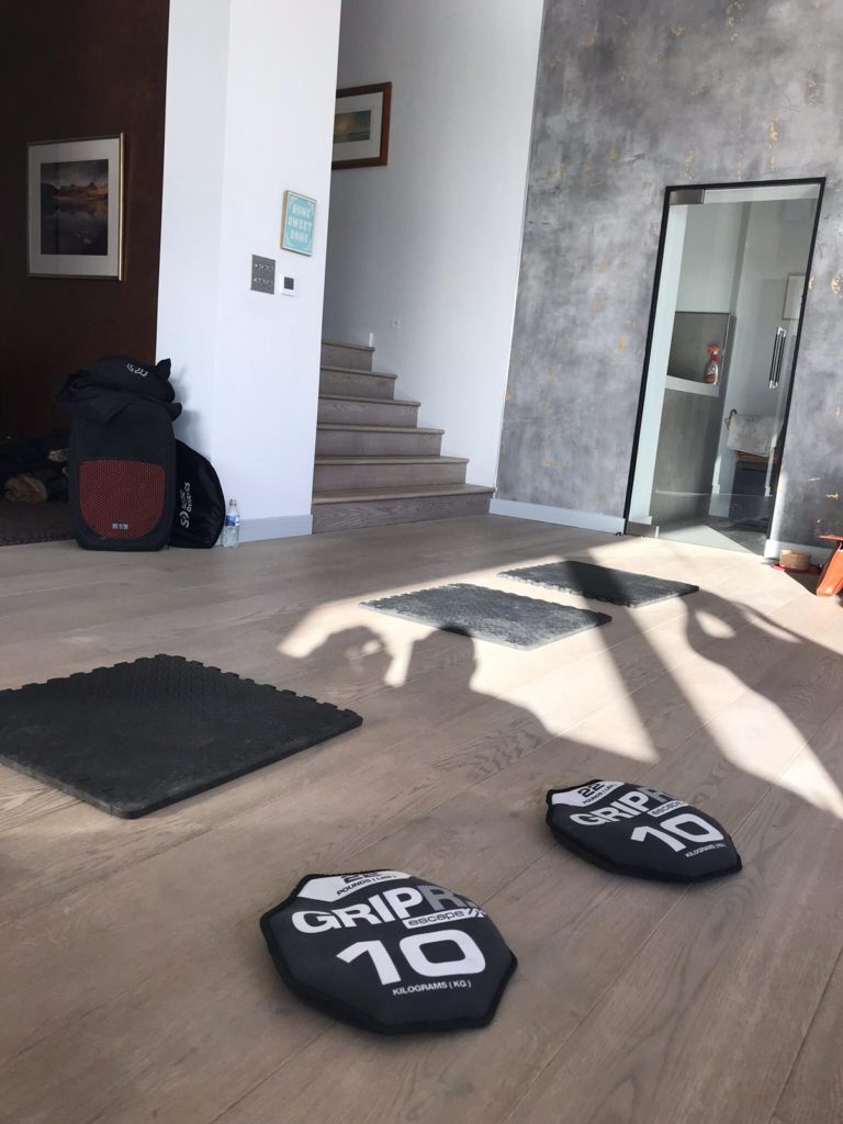 GRIPR branded excercise sandbags and floor mats on wooden floor