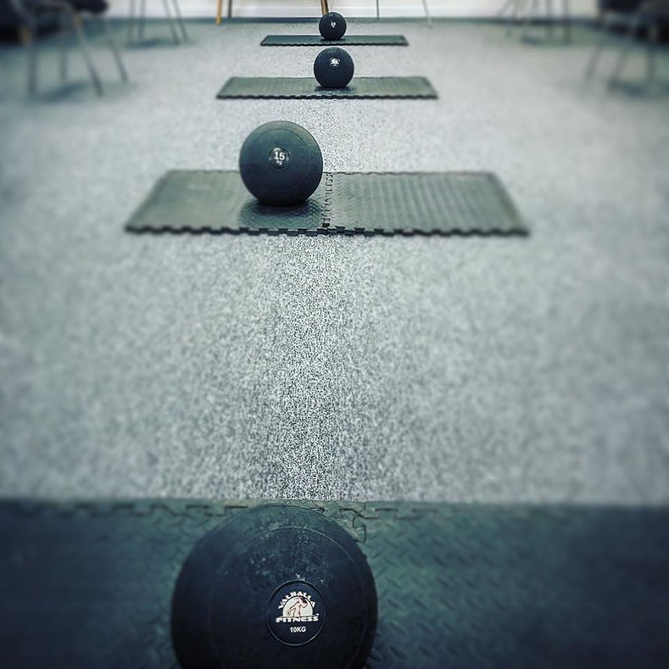 Medicine balls on fitness mats